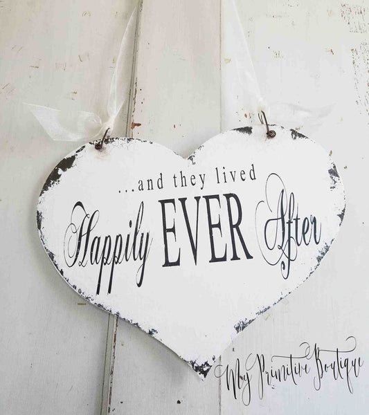 Rustic heart-shaped wedding sign reading ‘Happily Ever After’ hand painted in distressed ivory farmhouse style.
