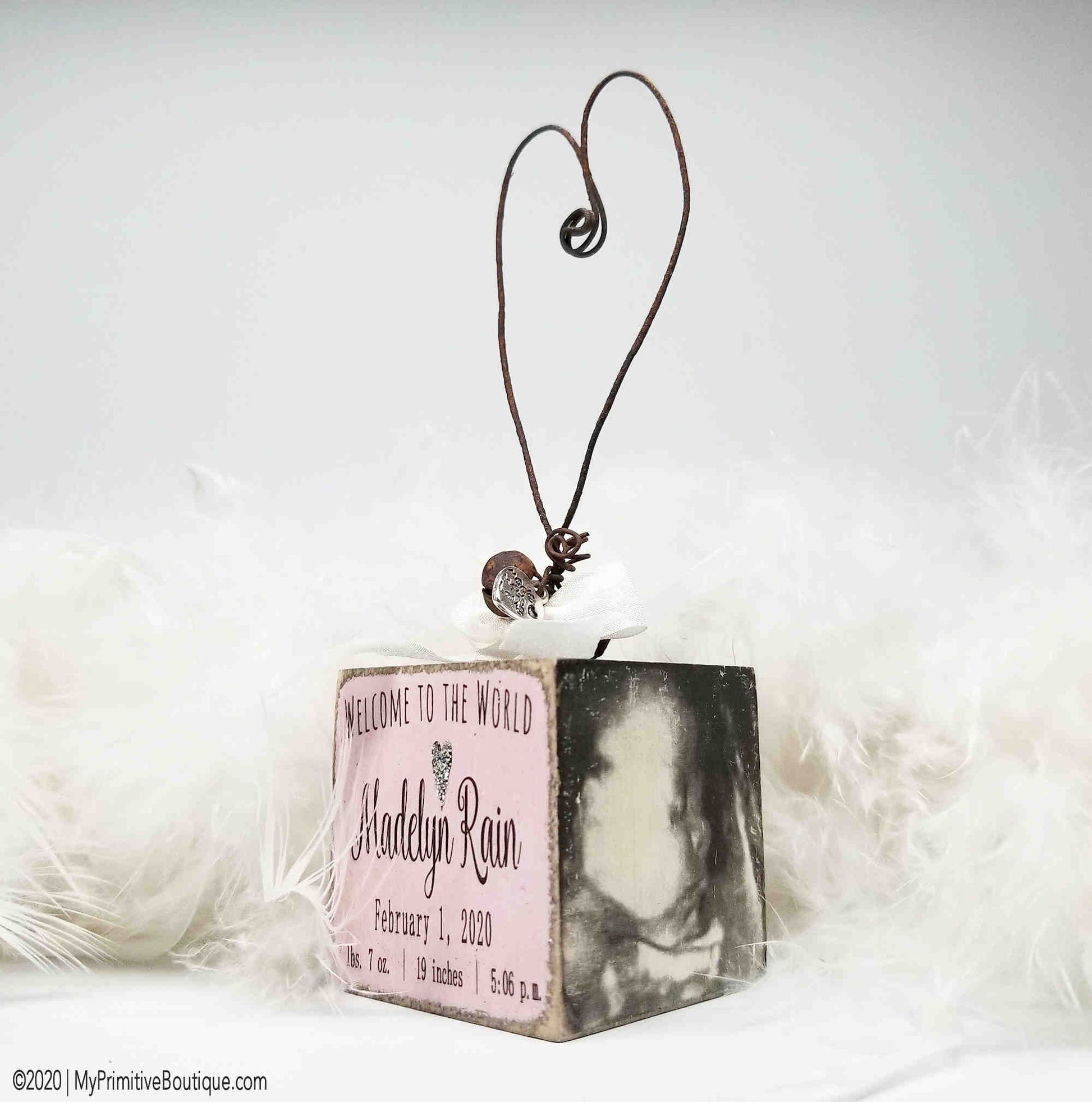 Rustic wooden baby ornament hand painted with Welcome to the World, personalized with name and date.