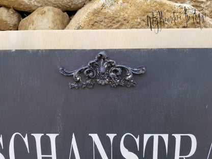 Close-up of rustic industrial wood sign with bold white lettering and black background