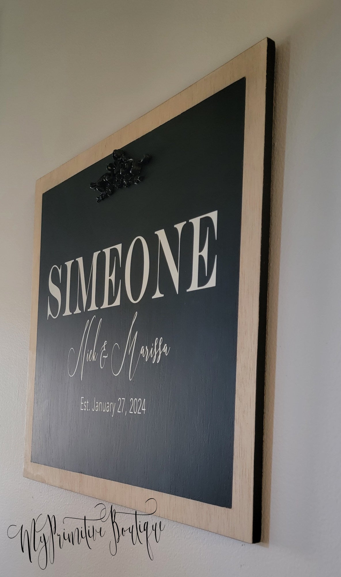 Large family name wall sign with dimensional accent.